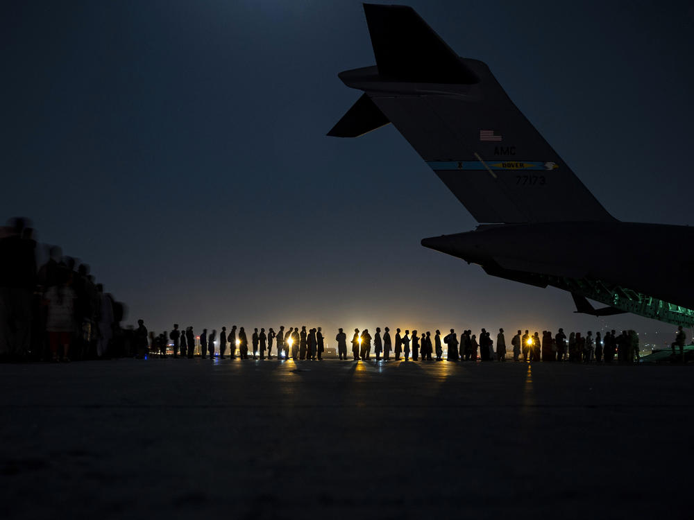 U.S. Air Force aircrew prepare to load qualified evacuees aboard a U.S. Air Force C-17 Globemaster III aircraft in support of the Afghanistan evacuation in August, 2021.