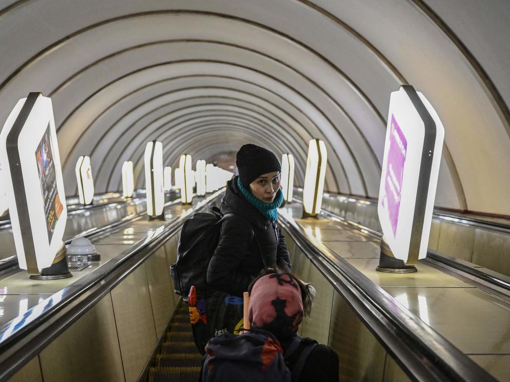 A woman takes her belongings to an underground metro station, used as bomb shelter in Kyiv on March 2 in the early days of the war.