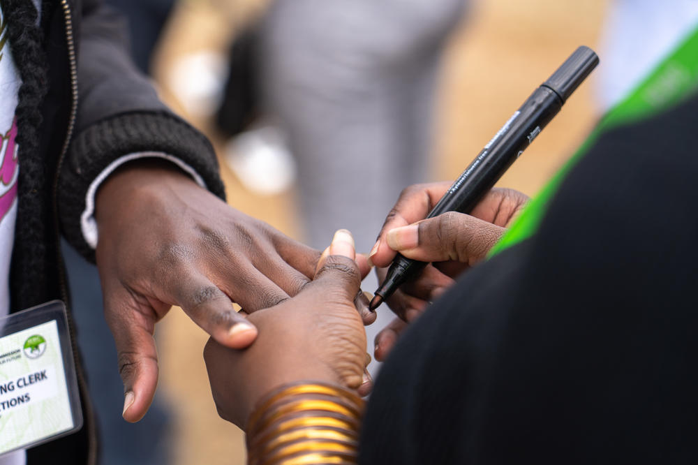 An election official marks the nail of a voter to indicate they have cast their ballots and completed voting at a polling station in the Mathare neighborhood of Nairobi.