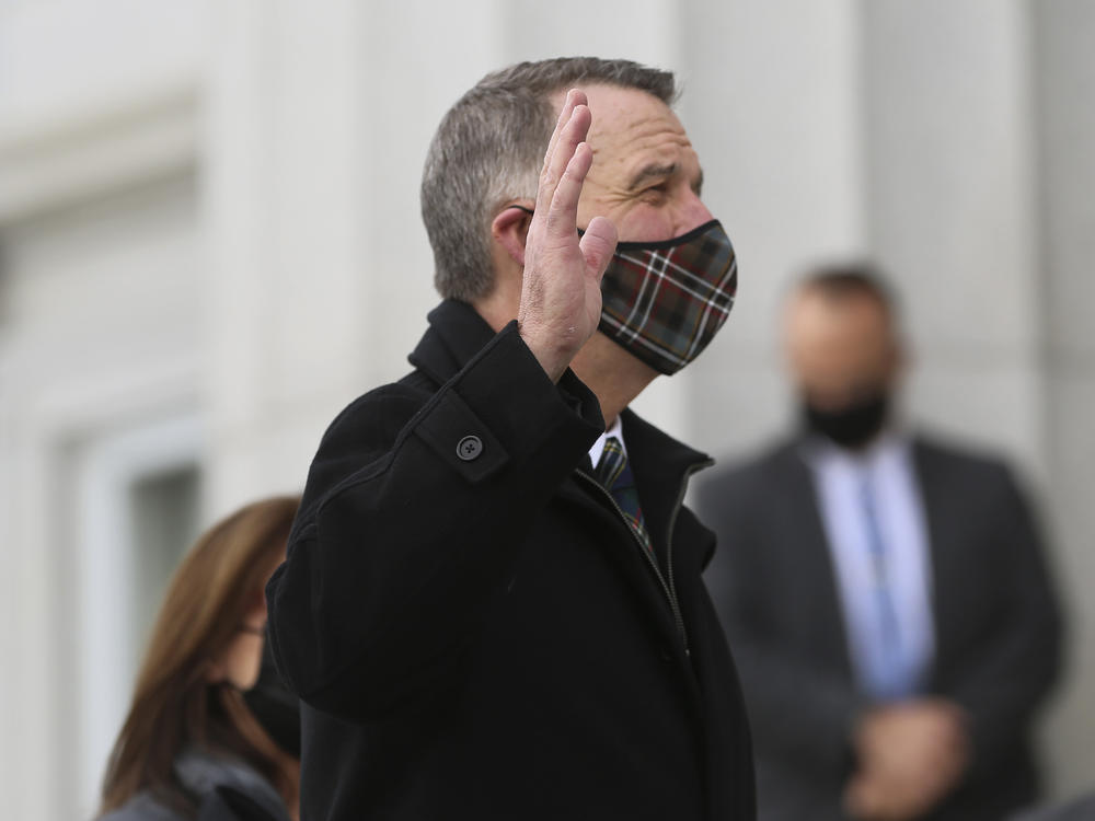 Thursday, Jan. 7, 2021, Republican Gov. Phil Scott wears a mask as he takes the Oath of Office on the steps of the Vermont Statehouse in Montpelier, Vt., beginning his third two-year term. Vermont is one of two states that holds elections for governor every two years.