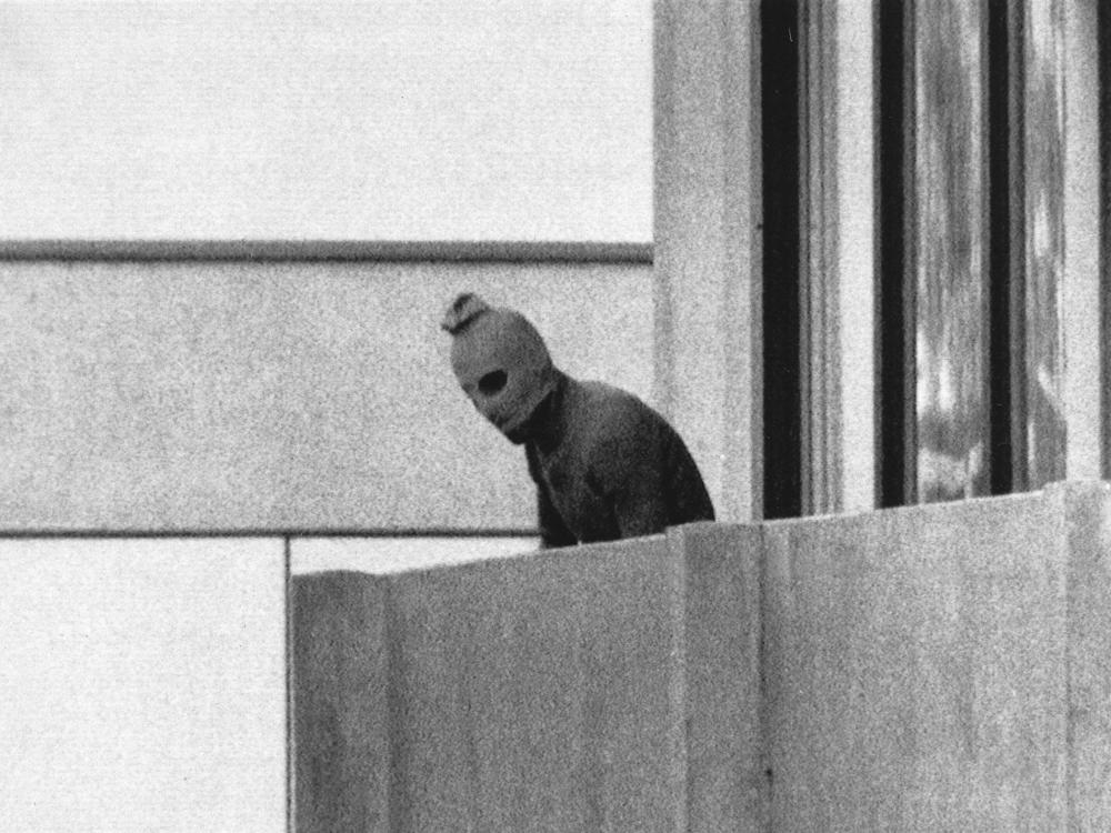 A member of Black September appears on the balcony of the apartment where gunmen held members of the Israeli Olympic team hostage on Sept. 5, 1972. It was the first time a terrorist attack had been broadcast live to a global audience.