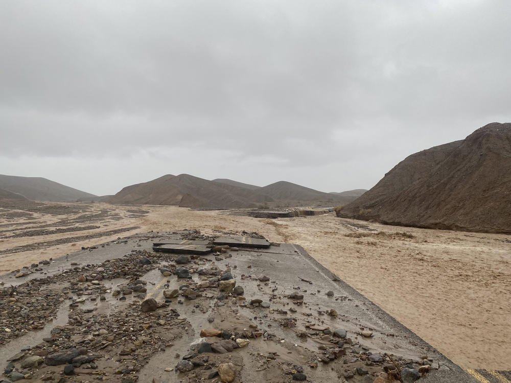 Mud Canyon Road is closed due to flash flooding in Death Valley, Calif., on Friday. Authorities say the main roadway into Death Valley National Park will remain closed as crews clean up after record-breaking rains damaged the roadway and choked it with mud, rocks and debris.