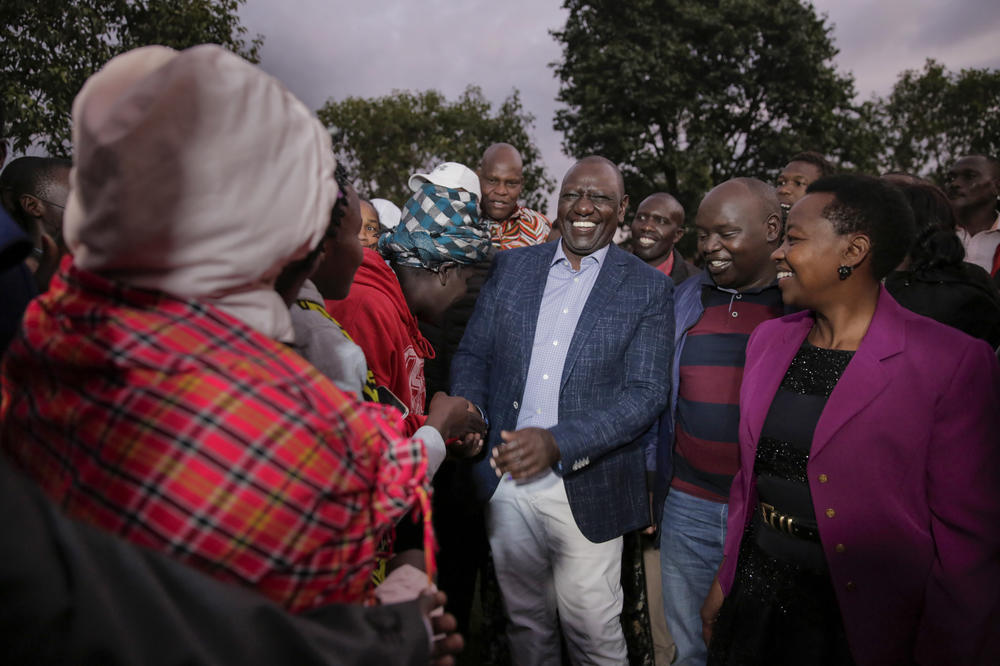 Deputy President and presidential candidate William Ruto, center, greets supporters after casting his vote in Kenya's general election in Sugoi. Kenyans are voting to choose between opposition leader Raila Odinga and Ruto to succeed President Uhuru Kenyatta after a decade in power.