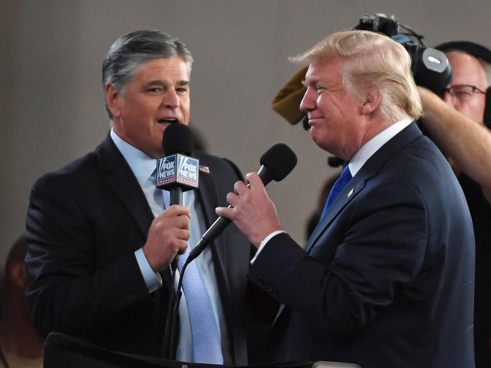 Fox News Channel and other conservative media largely leapt to former President Donald Trump's defense after the FBI searched his Mar-a-Lago resort. Here, Fox star and ally Sean Hannity (L) interviews Trump before a campaign rally in 2018 in Las Vegas.