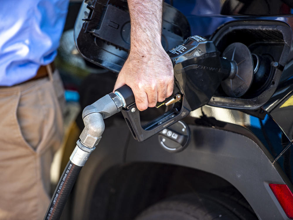 A driver pumps gas at a Gulf gas station in Lynnfield, Mass., on July 19. Gasoline prices are dropping, which is helping bring down inflation. But the cost of many other things are still climbing.