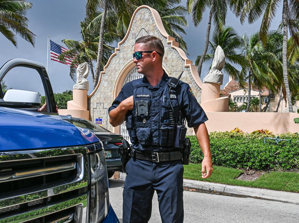 Local law enforcement officers are seen in front of the home of former President Donald Trump at Mar-a-Lago in Palm Beach, Fla., on Tuesday.