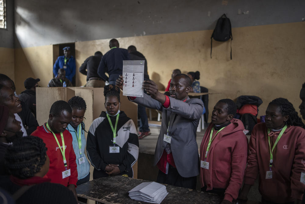 Independent Electoral and Boundaries Commission officials count votes at the Mathare North Social Hall polling station during the presidential election in Nairobi.