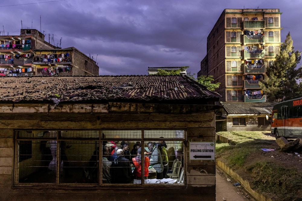 Electoral Commission Officials count votes inside a polling station after the official closing of the polls during Kenya's general election at Mathare Social Hall in Nairobi.