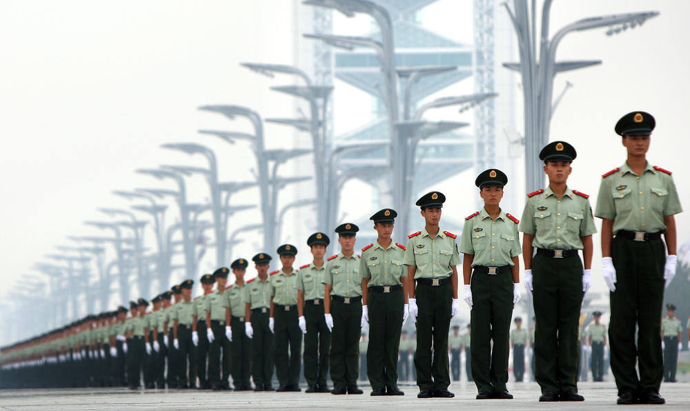 Chinese police officers stand at the Olympic Green ahead of the Beijing Olympics on Aug. 6, 2008. China spent $6.5 billion on security for the 2008 Games, part of a trend toward enormous Olympic security budgets.