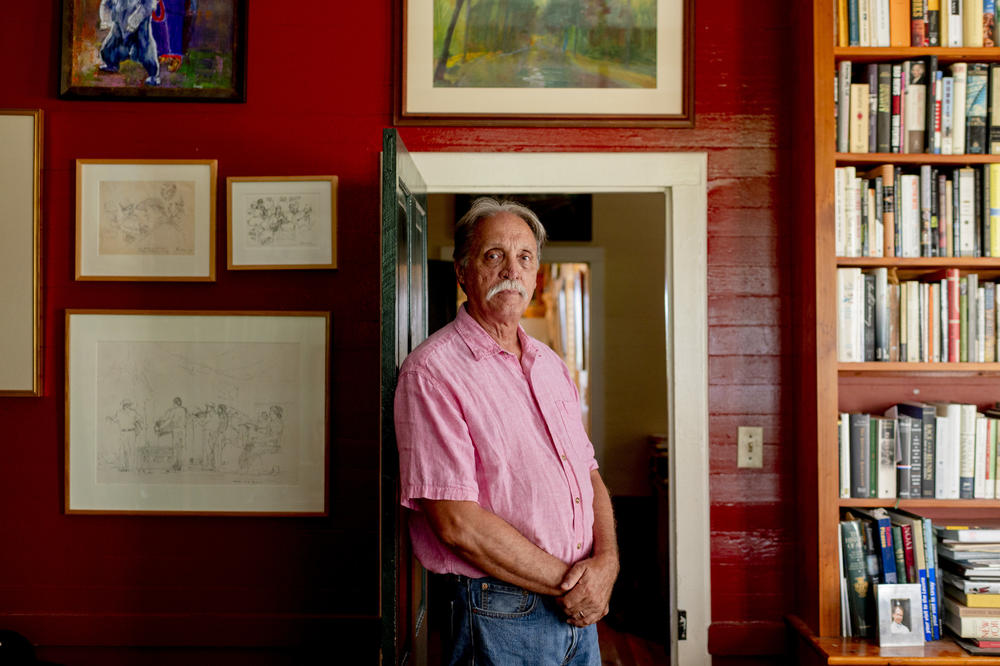Barry Ancelet poses for a portrait in his home in Ossun, La.