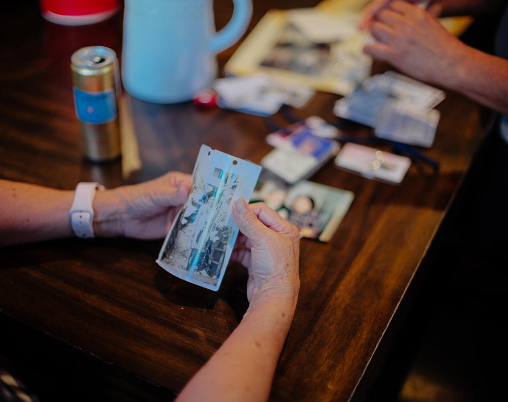 Sifting through old photos on July 14, 2022, Perez, the owner of Hillcrest Care, a small assisted-living facility in El Dorado Hills, Calif., relishes the vignettes of family life back in the Philippines.