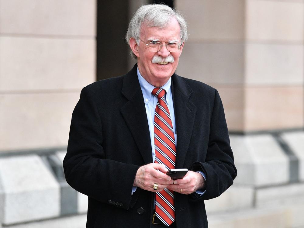 Former US National Security adviser John Bolton smiles in Westminster, London on November 16, 2021.