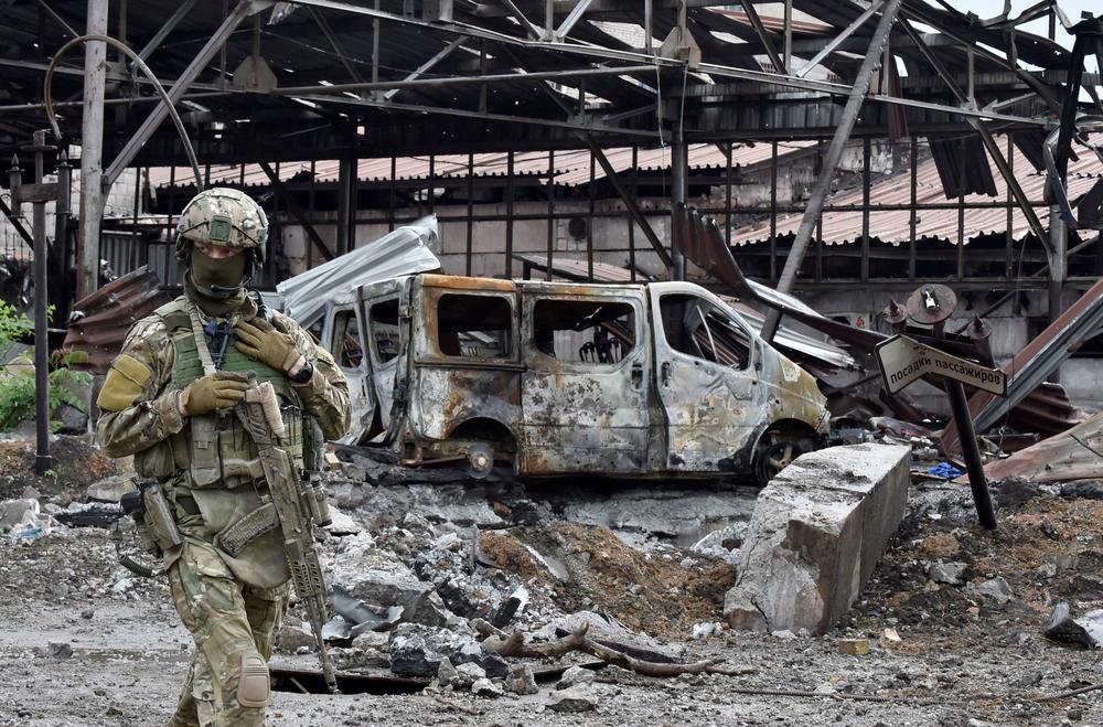 A Russian serviceman patrols the destroyed part of the Ilyich Iron and Steel Works in Ukraine's port city of Mariupol on May 18.