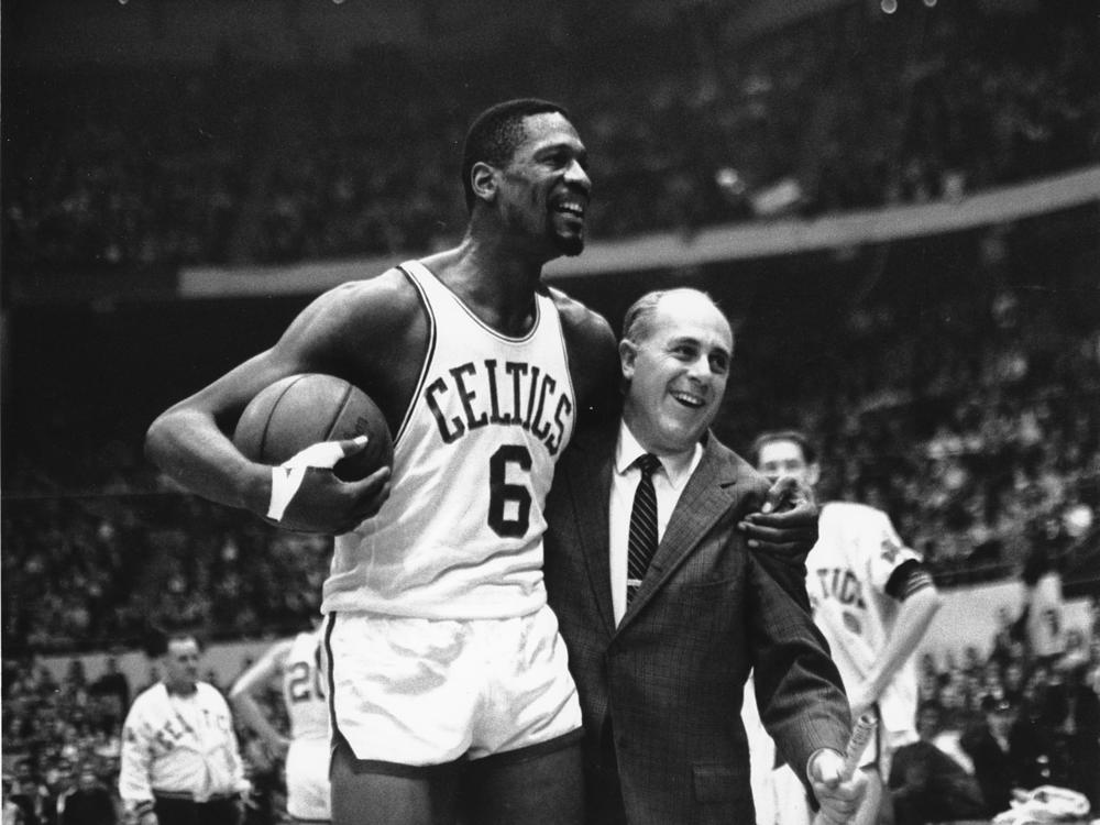 Bill Russell (left) star of the Boston Celtics is congratulated by coach Arnold 