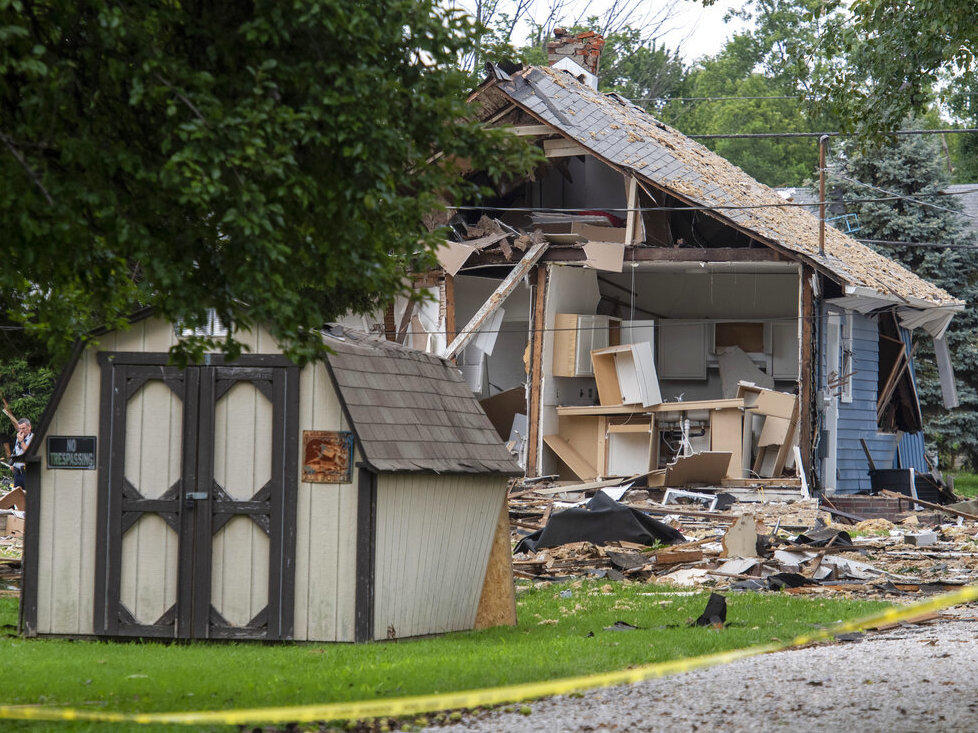 Emergency crews respond to a house explosion Wednesday in Evansville, Ind. (MaCabe Brown/Evansville Courier & Press via AP)