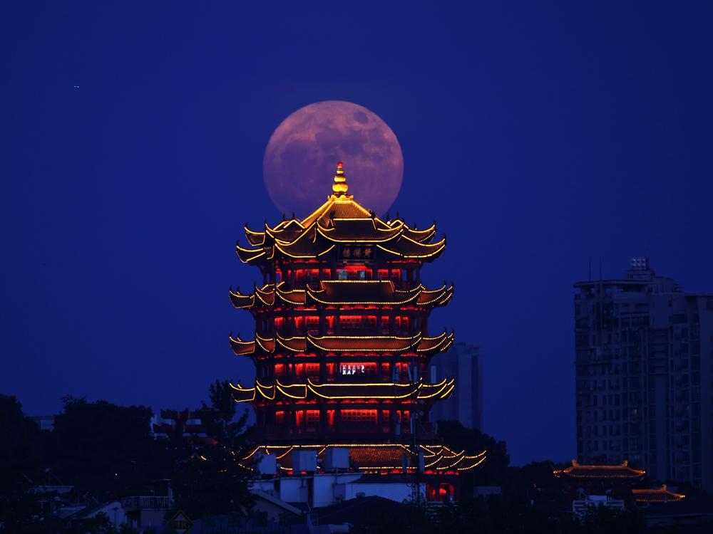 A supermoon is pictured near the Yellow Crane Tower in Wuhan, central China's Hubei Province, July 13, 2022.