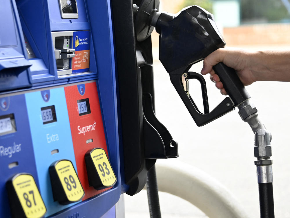 A person goes to the pump at a gas station in Arlington, Va., on July 29. The national average price of gasoline fell below $4 a gallon on Thursday.