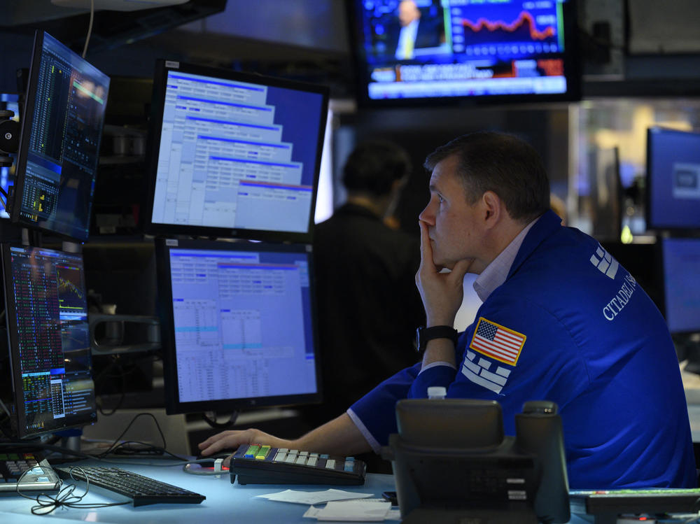 A trader works on the floor of the New York Stock Exchange in New York City on Aug. 5. The majority of America's top companies have reported strong earnings, but warning signs about the economy are also emerging from their corporate earnings.