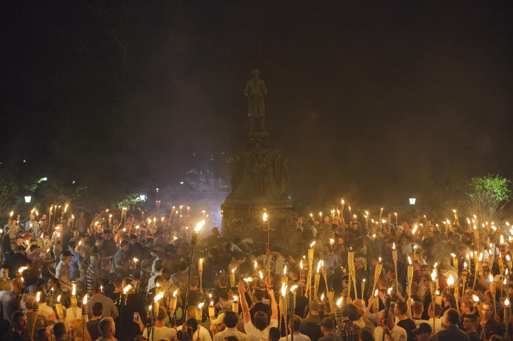 Neo-Nazis, alt-right supporters and white supremacists encircle counter-protestors at the base of a statue of Thomas Jefferson after marching through the University of Virginia campus with torches in Charlottesville, Va., on Aug. 11, 2017.