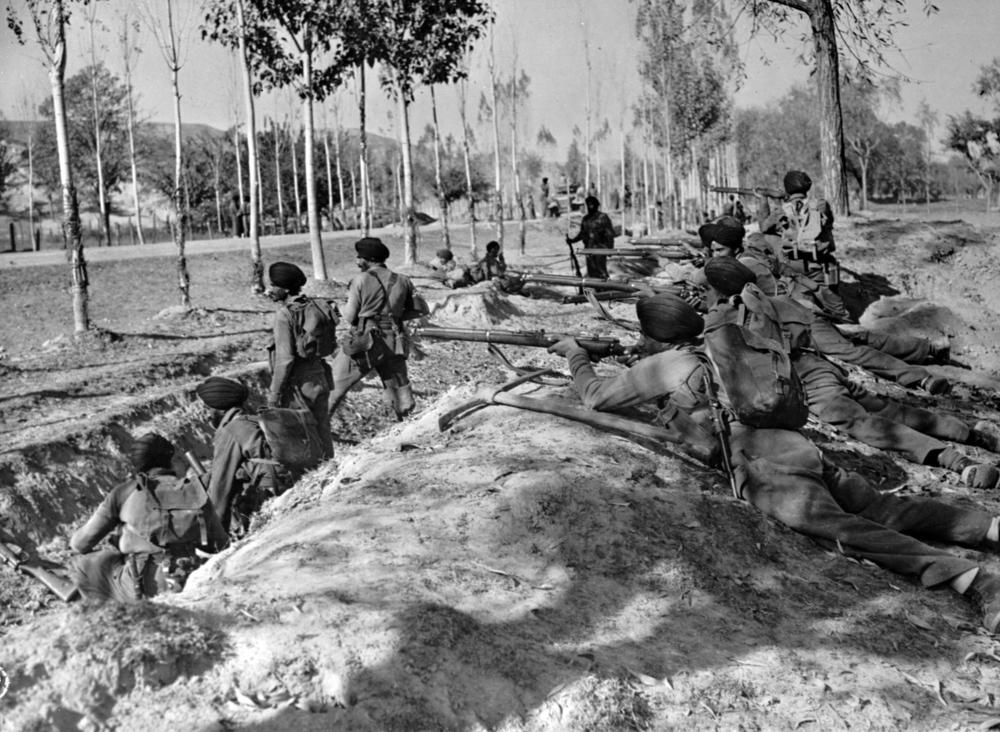 In this Nov. 9, 1947, file photo, Indian Sikh troops take up roadside positions on the Baramula Road to help force armed invaders from Pakistan further away from Srinagar in Kashmir. India and Pakistan fought a yearlong war over control of Muslim-majority Kashmir. The war ended with a U.N.-brokered cease-fire leaving Kashmir divided between the two young nations.