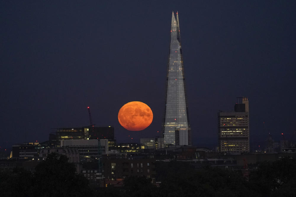 London: The supermoon rises behind The Shard.