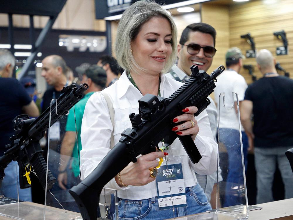 A visitor holds a weapon during the Shot Fair Brasil, an arms exhibition held at the Expoville Conventions and Exhibitions Center in Joinville, Santa Catarina state, Brazil, on Aug. 5.