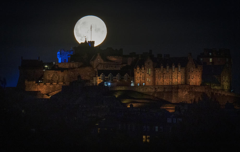 Edinburgh, Scotland: The Sturgeon supermoon, the final supermoon of the year, rises behind Edinburgh Castle.