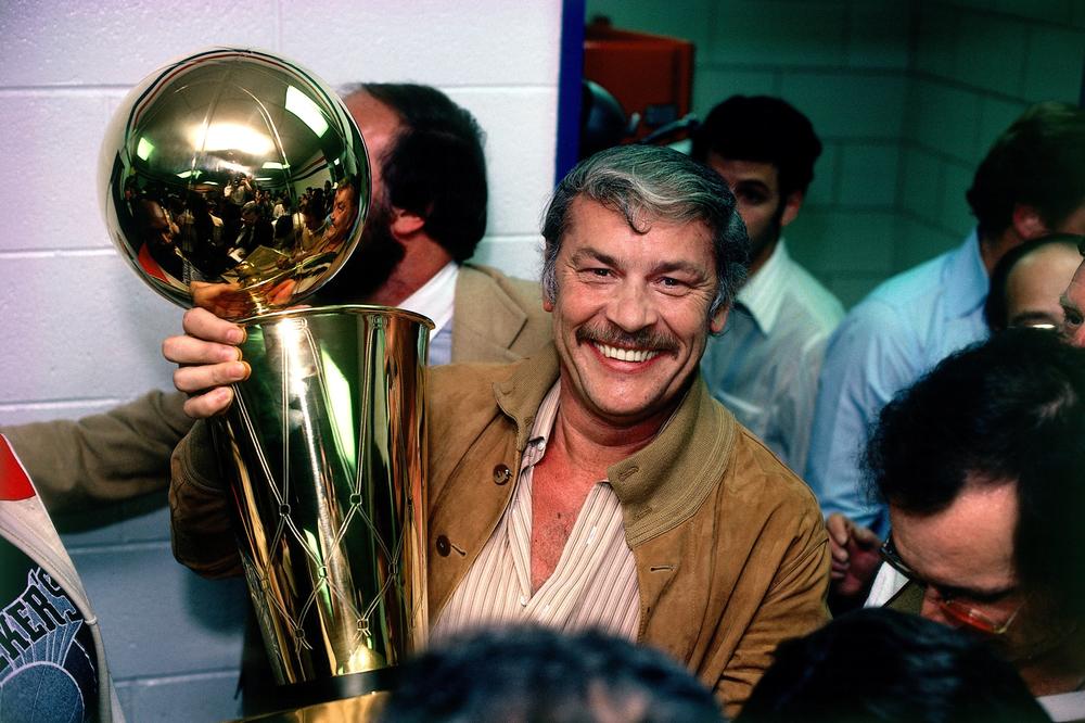 Los Angeles Lakers owner Jerry Buss poses with the NBA Championship trophy after Game 6 of the NBA Finals on May 16, 1980 at the Spectrum in Philadelphia, Pennsylvania.