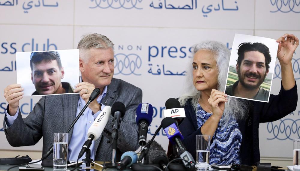 Marc and Debra Tice, parents of American journalist Austin Tice, who was kidnapped in Syria in 2012, hold portraits of him during a news conference in Beirut in 2017.