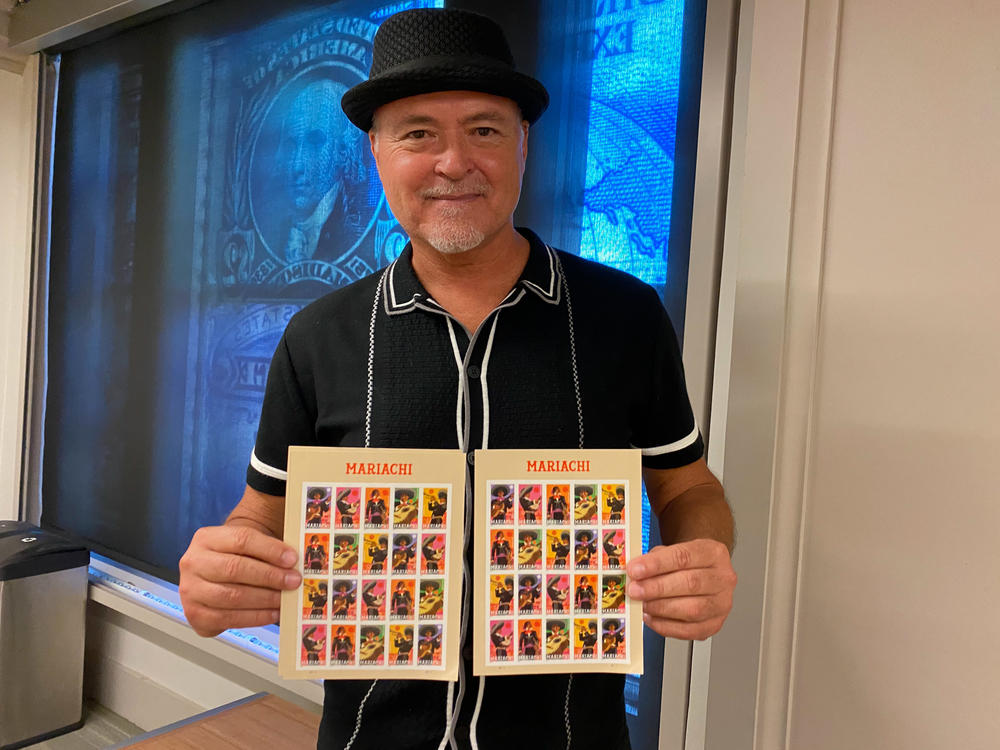 Rafael López poses with his mariachi stamps in a classroom at the Smithsonian's National Postal Museum. The set was launched in August.