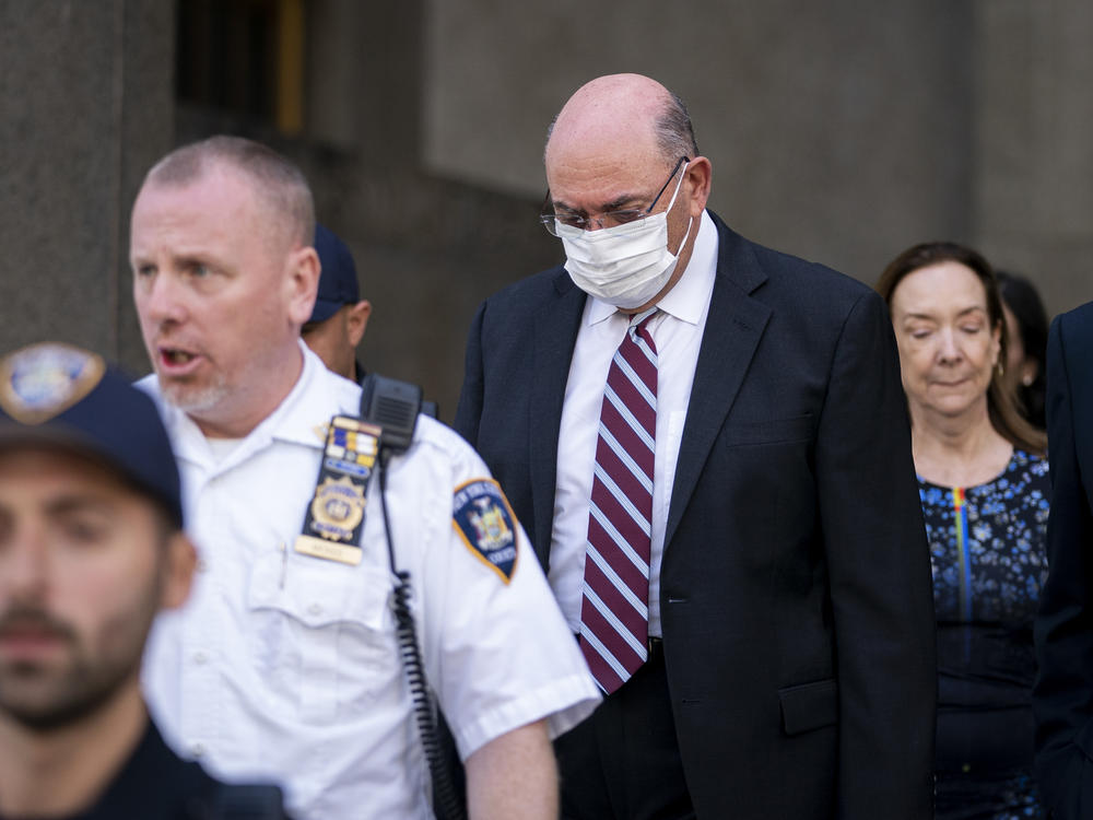 The Trump Organization's longtime chief financial officer, Allen Weisselberg (wearing mask), leaves court in New York on Friday.