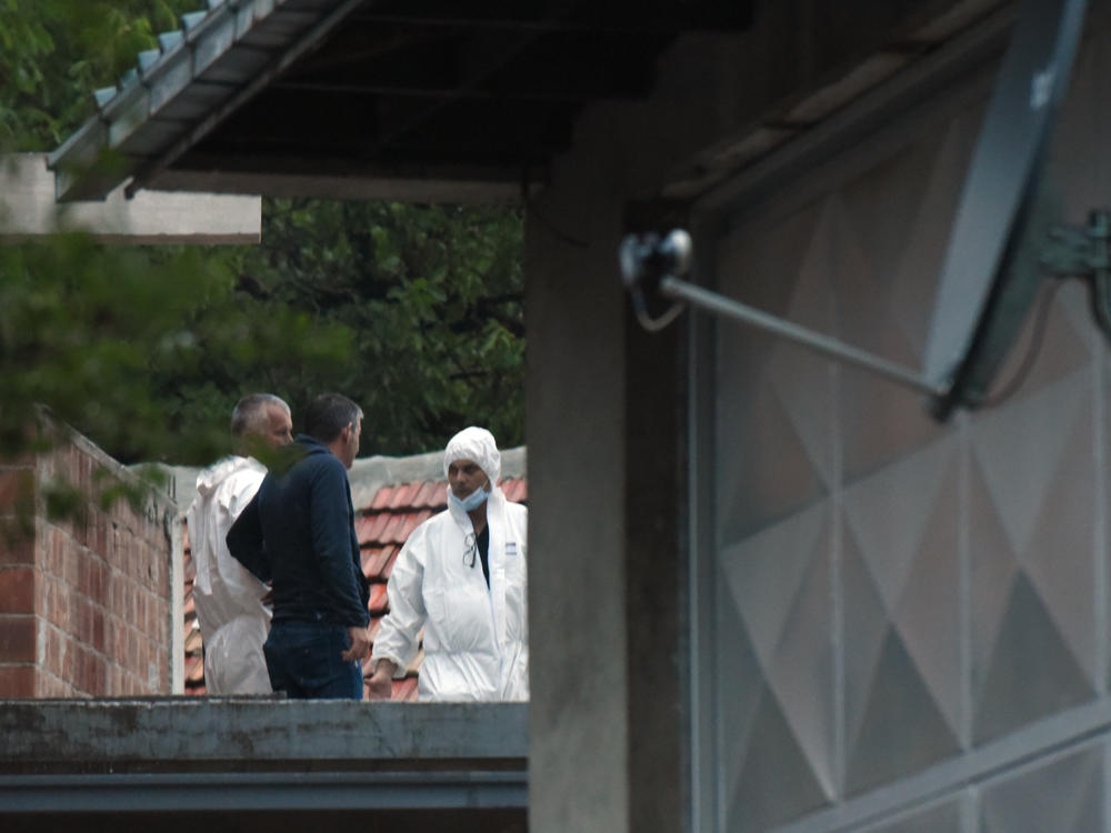 Police investigators work at the site of the attack in Cetinje, Montenegro, on Friday.