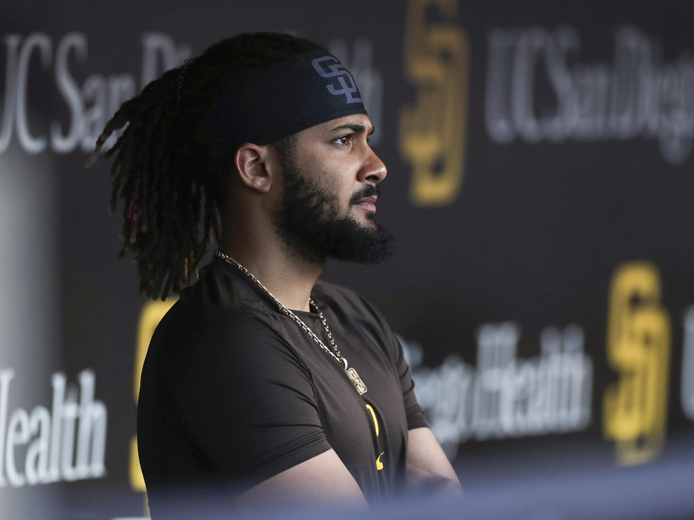 San Diego Padres' Fernando Tatis Jr. looks out from the dugout prior to the team's game against the Philadelphia Phillies on June 25 in San Diego. Tatis was suspended 80 games by Major League Baseball on Friday after testing positive for a performance-enhancing substance.