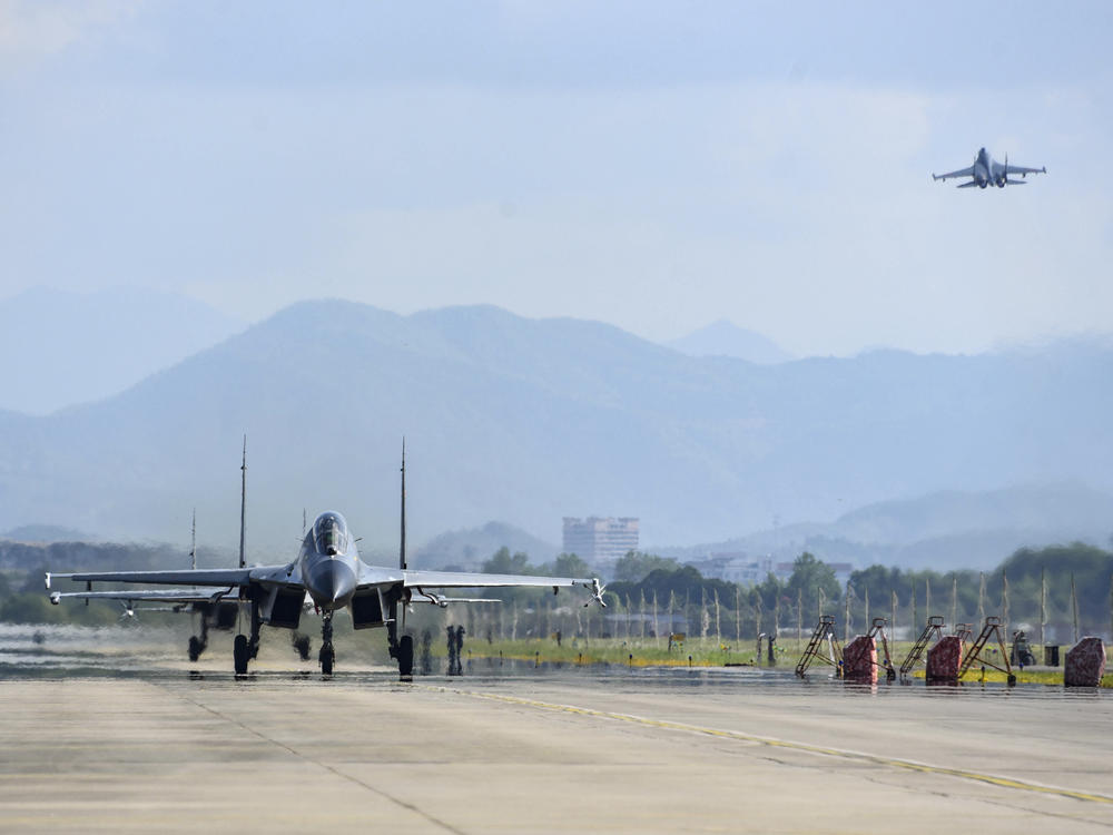In this photo released by China's Xinhua News Agency, air force and naval aviation corps of the Eastern Theater Command of the Chinese People's Liberation Army (PLA) fly planes at an unspecified location in China on Aug. 4.