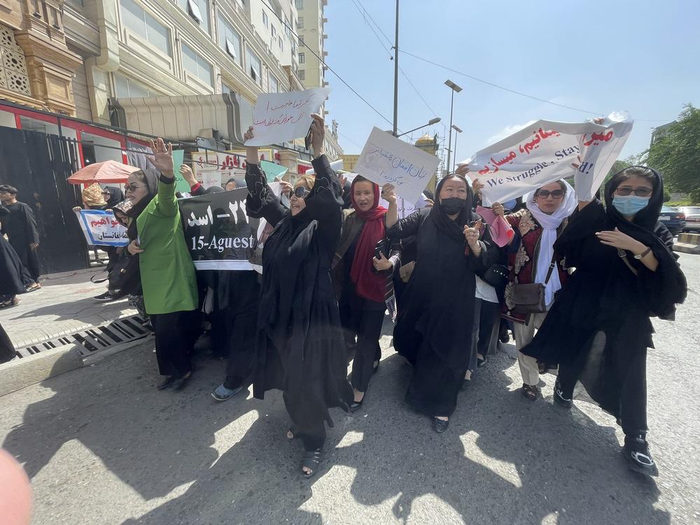 Women march down a main street in Kabul on Saturday, two days before the one-year anniversary of the Taliban takeover.