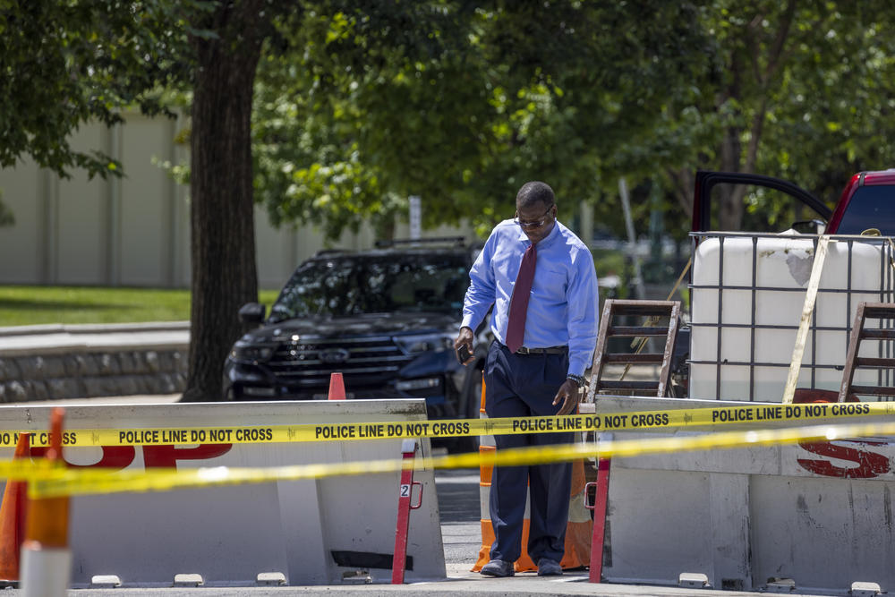 A worker looks over the area where a man, identified by officials as Richard A. York III of Delaware, crashed into a barricade at the U.S. Capitol on Sunday.