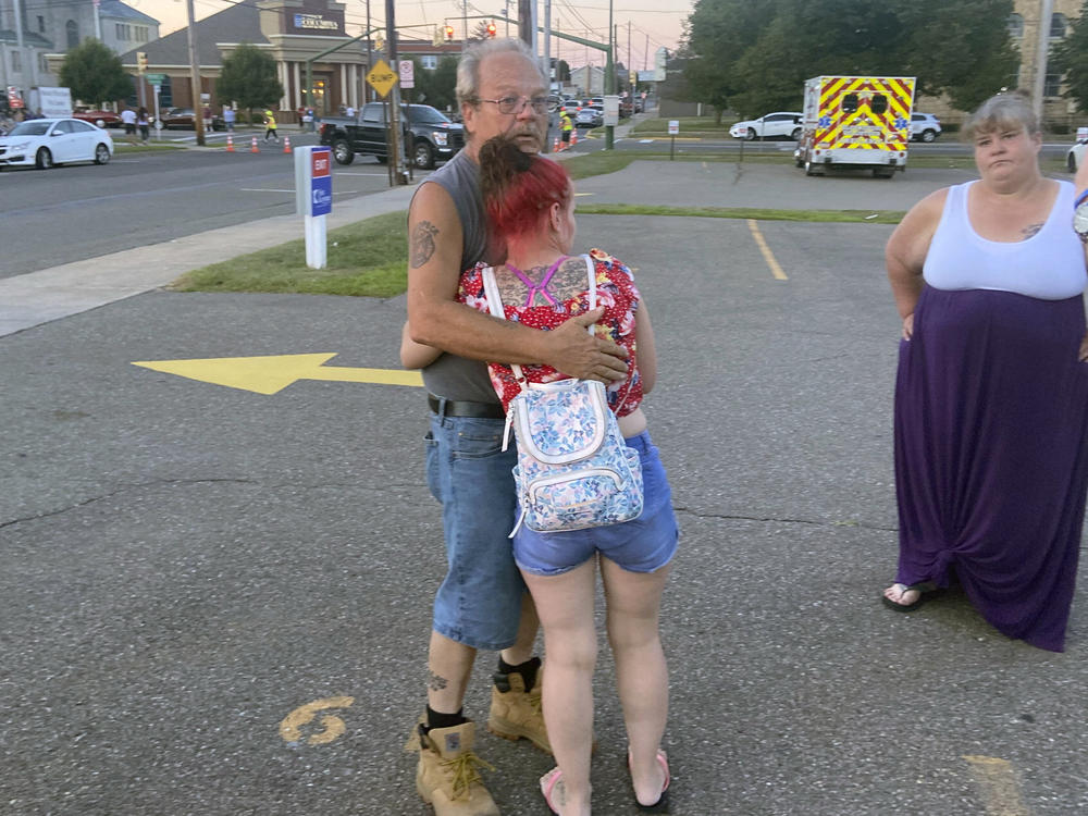 Nescopeck Volunteer Fire Company firefighter Harold Baker is comforted at the scene in Berwick, Pa., Saturday, Aug. 13, 2022.