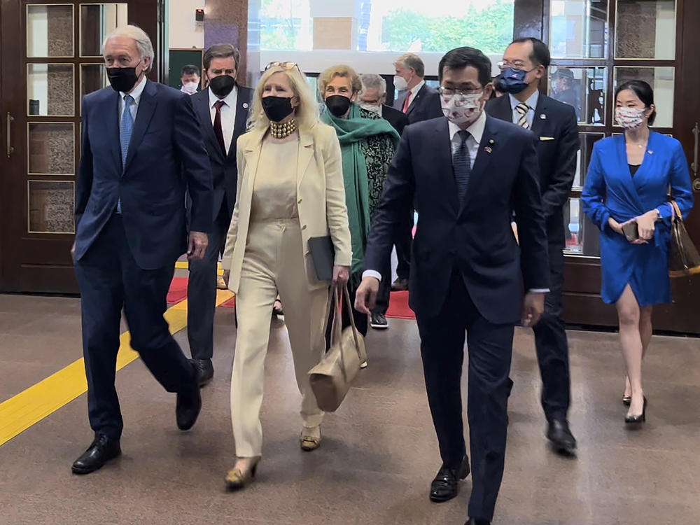 U.S. Democrat Sen. Ed Markey of Massachusetts, left, and Democratic House member John Garamendi of California, second left, back, arrive with their wives at the parliament building in Taipei, on Aug. 15, 2022.