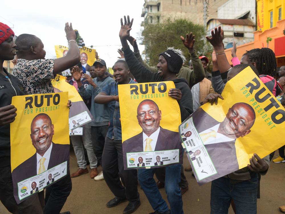 Supporters of Kenya's president-elect William Ruto hold posters of him as they gather while waiting for results of Kenya's general election in Eldoret, Kenya, on Monday.