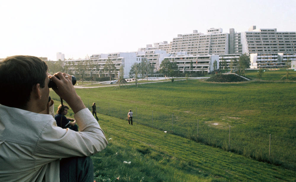 A man with binoculars surveys the Olympic Village in Munich during the hostage-taking of members of Israel's Olympic team in 1972.