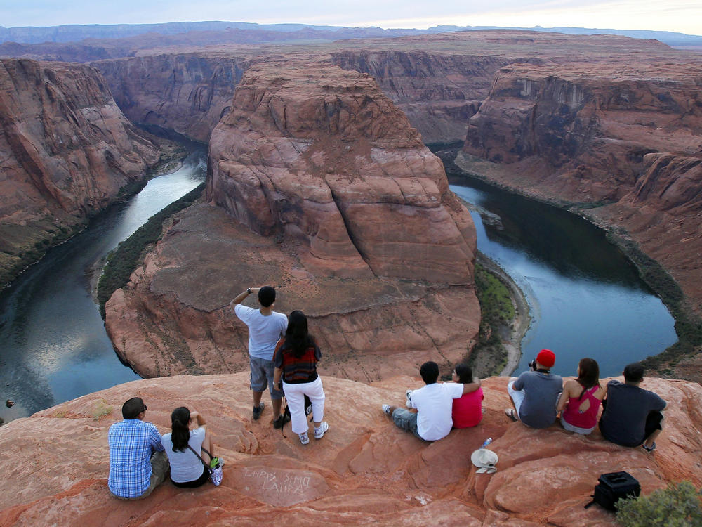 Visitors view the dramatic bend in the Colorado River at the popular Horseshoe Bend in Glen Canyon National Recreation Area, in Page, Ariz., on Sept. 9, 2011.
