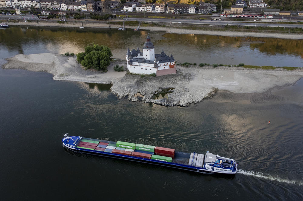 A container ship passes Pfalzgrafenstein Castle in the middle of the Rhine River in Kaub, Germany, Aug. 12. The Rhine carries low water after a long drought period.