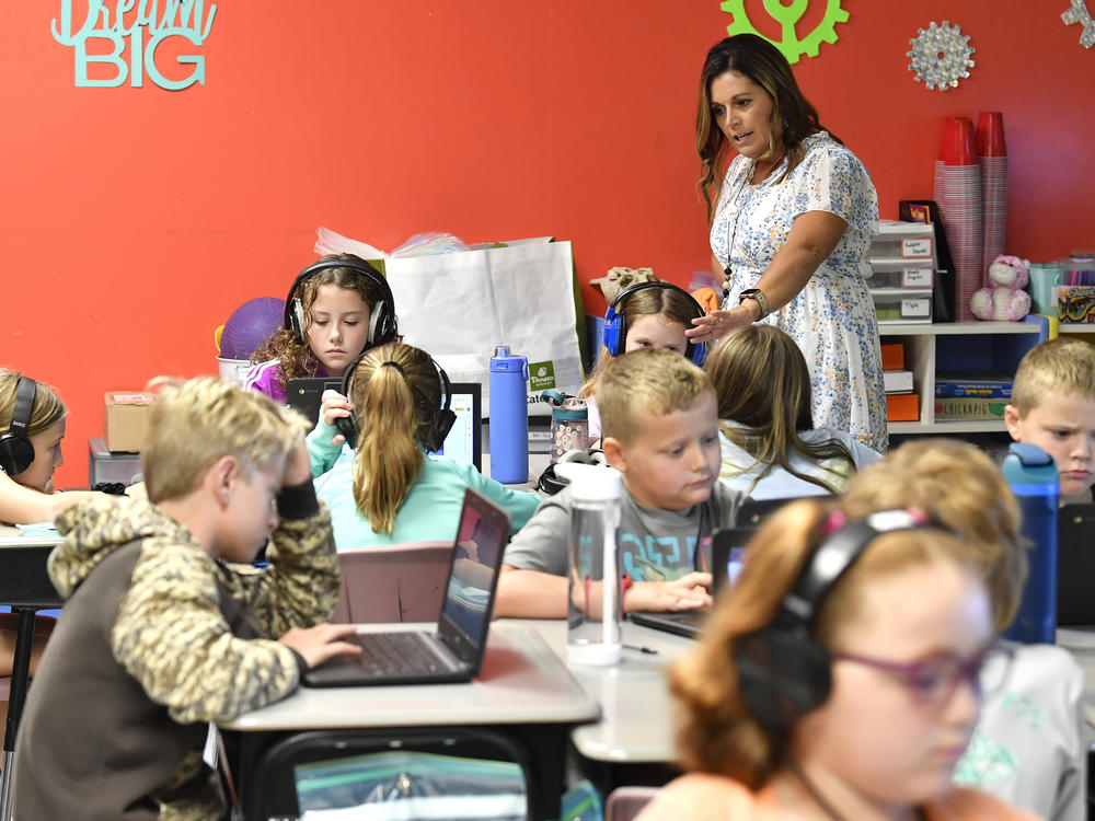 Angela Pike watches her fourth grade students at Lakewood Elementary School in Cecilia, Ky., as they use their laptops to participate in an emotional check-in at the start of the school day, Thursday, Aug. 11, 2022.