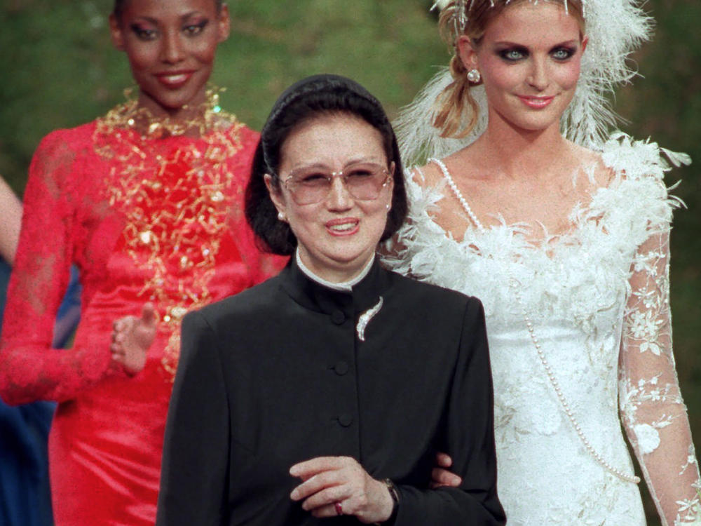 Japanese fashion designer Hanae Mori, center, is applauded by models after the presentation of her 1997-98 fall-winter haute couture collection presented in Paris, July 9, 1997.