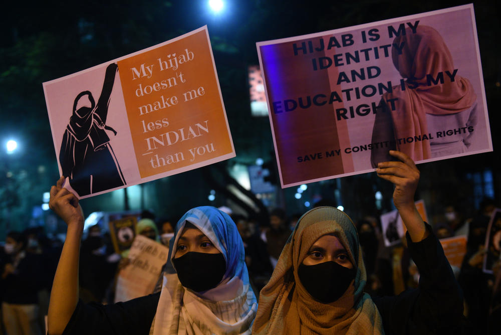 Activists hold placards during a candlelight protest against the hijab ban in Kolkata, India, on Feb. 11.