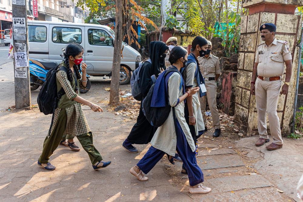 Students of the Government Pre-University College for Girls in Kundapur town, Udupi district, arrive at the school on Feb. 16. Schools reopened in southern India under tight security after authorities banned public gatherings following protests over Muslim girls wearing the hijab in classrooms.