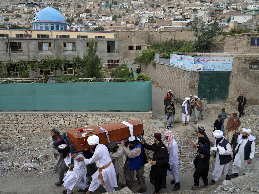 Mourners carry the body of a victim of a mosque bombing in Kabul, Afghanistan, Thursday, Aug. 18. 2022.