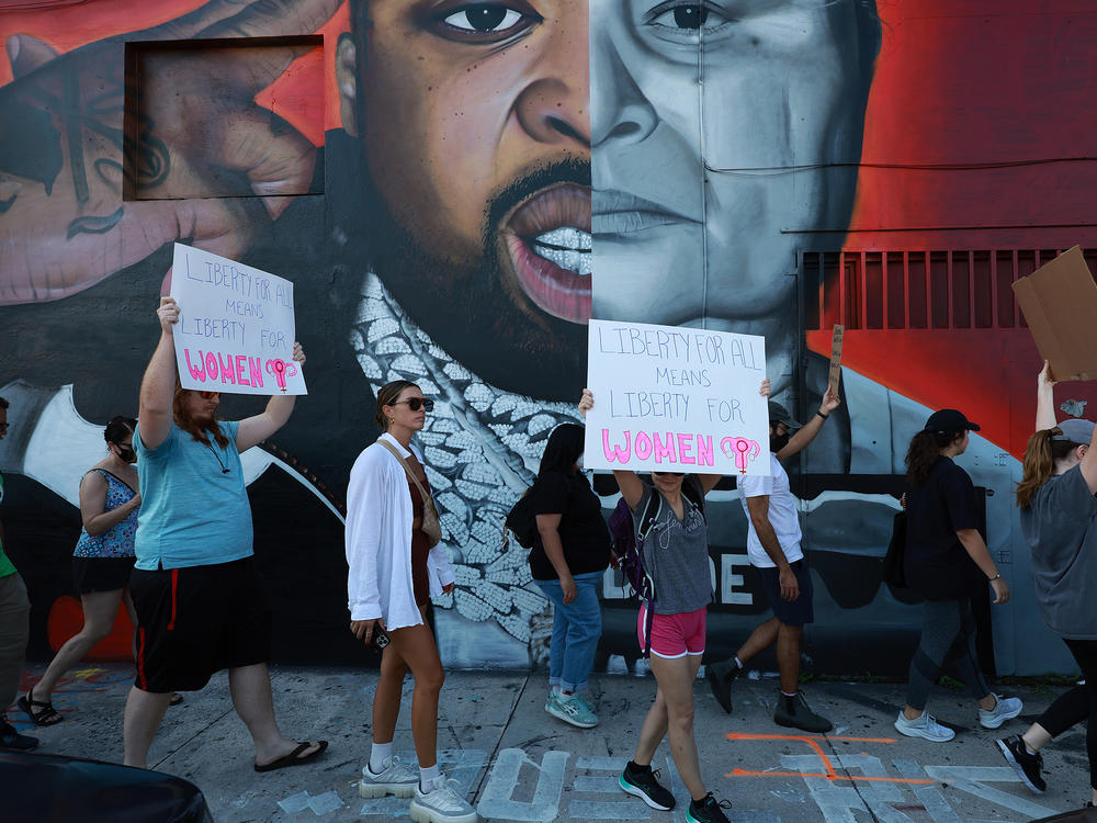 People march to protest the Supreme Court's decision in the <em>Dobbs v Jackson Women's Health</em> case on June 24 in Miami.
