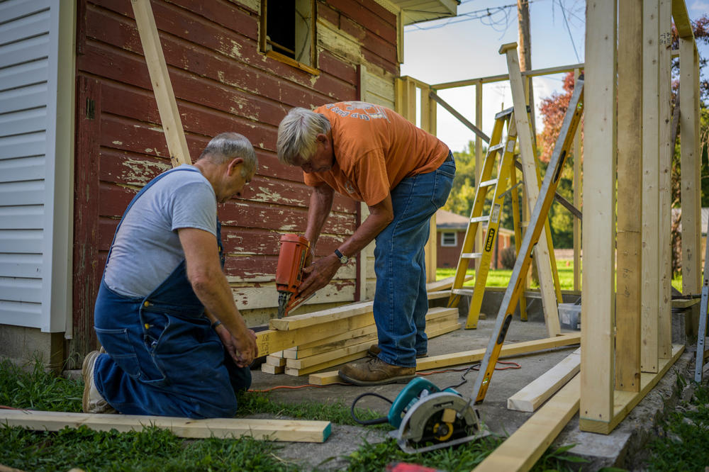 The flood forced many people to move away from Waverly, including relatives of Don Balthrop, right. He stayed, and has been getting help from Randy Dotson, left, to build a new shed for a neighbor.