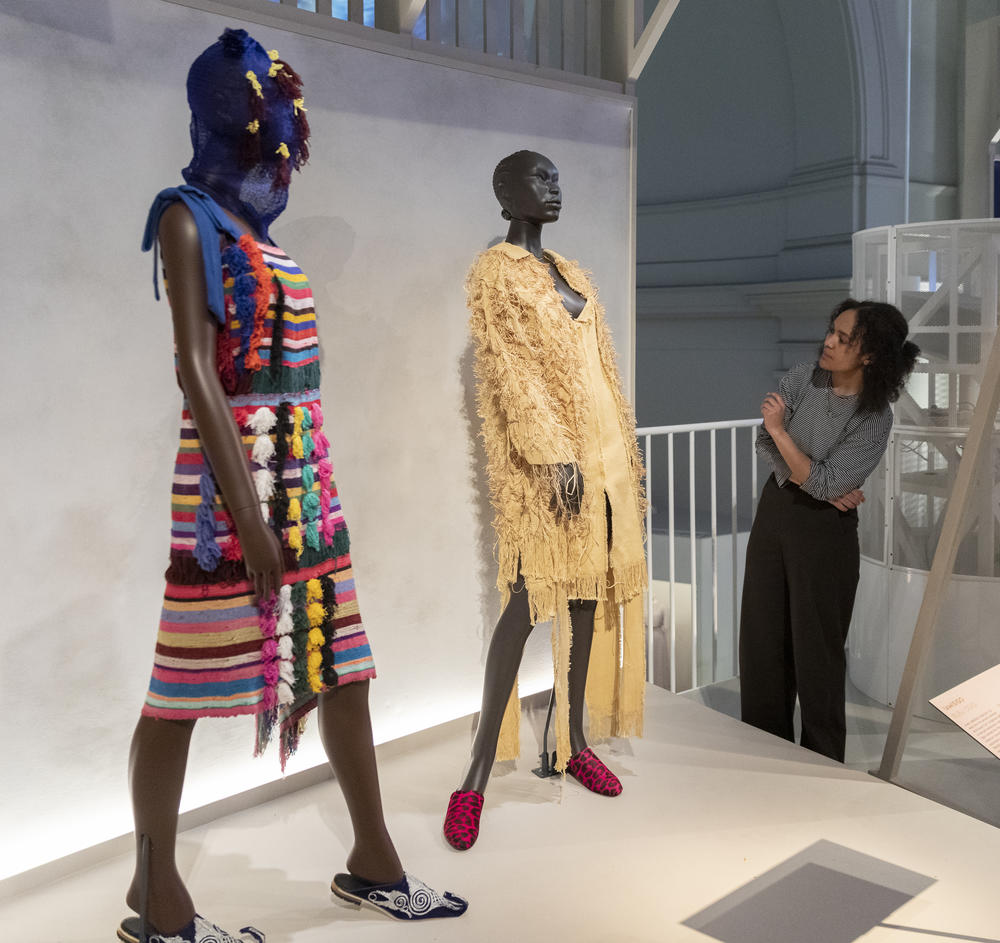 Two designs by Nigeria's Bubu Ogisi, who reimagines traditional styles and reinvigorates ancient materials. On the dress on the left, multi-colored tassels attached to the front of the dress create the kind of kaleidoscope effect found on the costumes worn by individuals in a community who act out the role of departed ancestors during ceremonies.